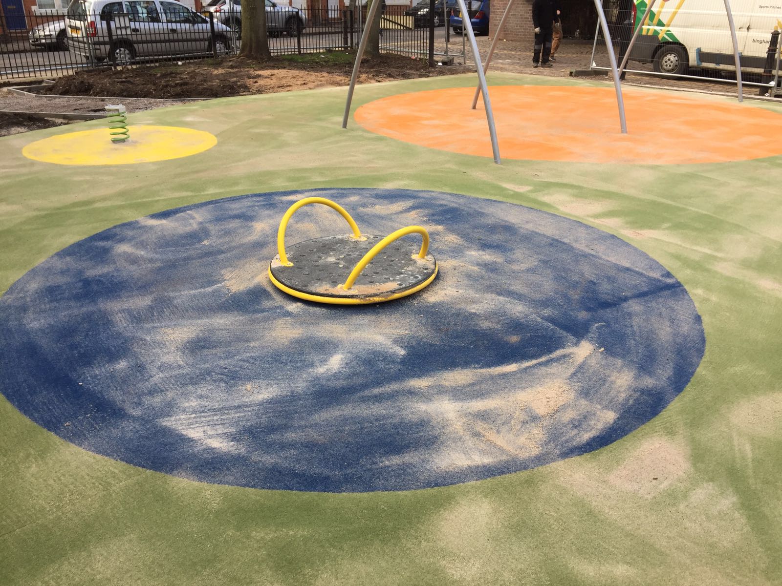 play area surfacing blue, green, orange and yellow.