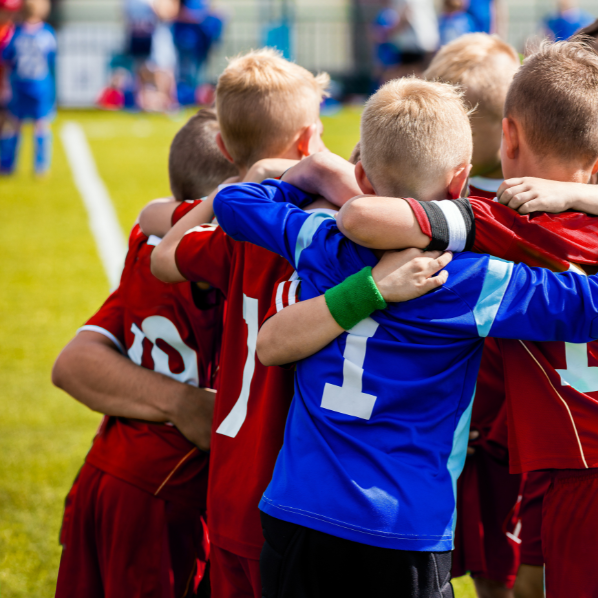 kids at football huddled together